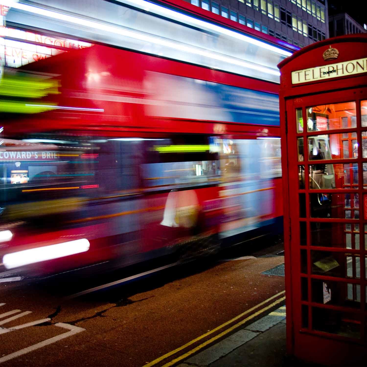 A London bus passes a telephone box on Haymarket.