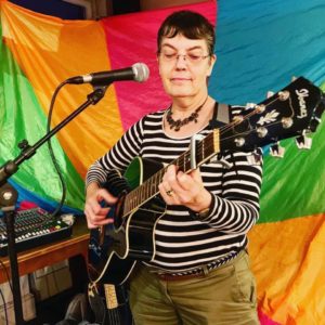 Christine Bennett playing the guitar